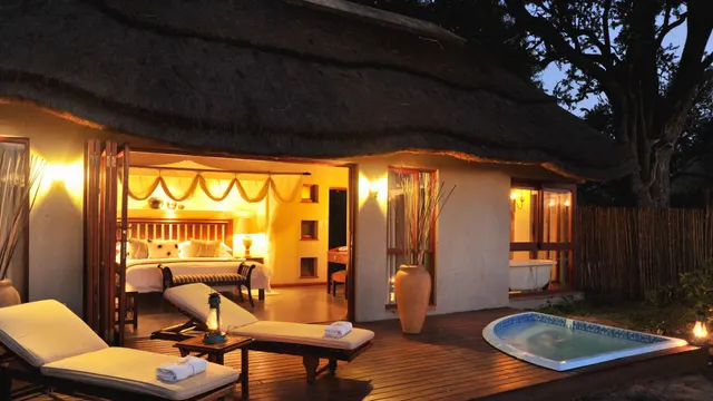 Safari suite bedroom opening onto a deck with a private plunge pool